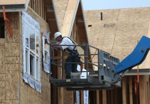 A construction worker installs a window in a new home in San Mateo, California. Housing starts need to pick up significantly if the supply and demand imbalance in Southern California is to be corrected.